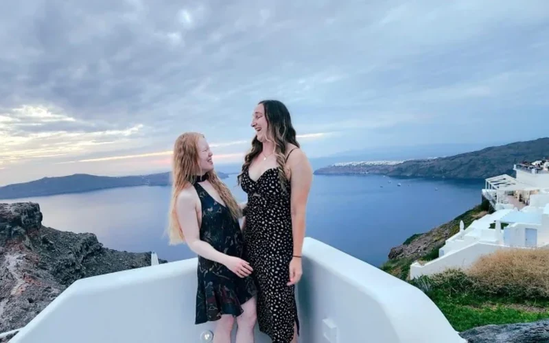 Marybai and Eliana in Greece, the ocean behind them.