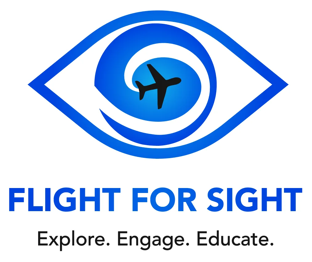 Logo of Blind Travel Foundation: Outline of an eye is blue. There is a black plane that is swirled in the middle of a blue eye. Below reads Blind Travel Foundation all in capital letters. Below that reads "Explore. Engage. Educate."