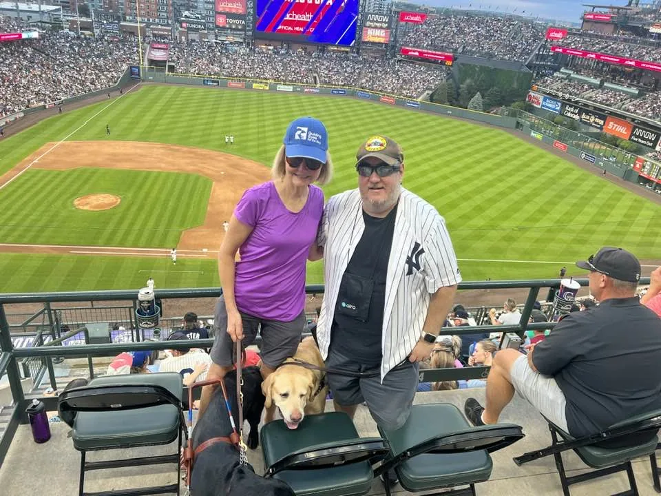 Barbara, Brian and his guide dog Wesley at Coors Field.