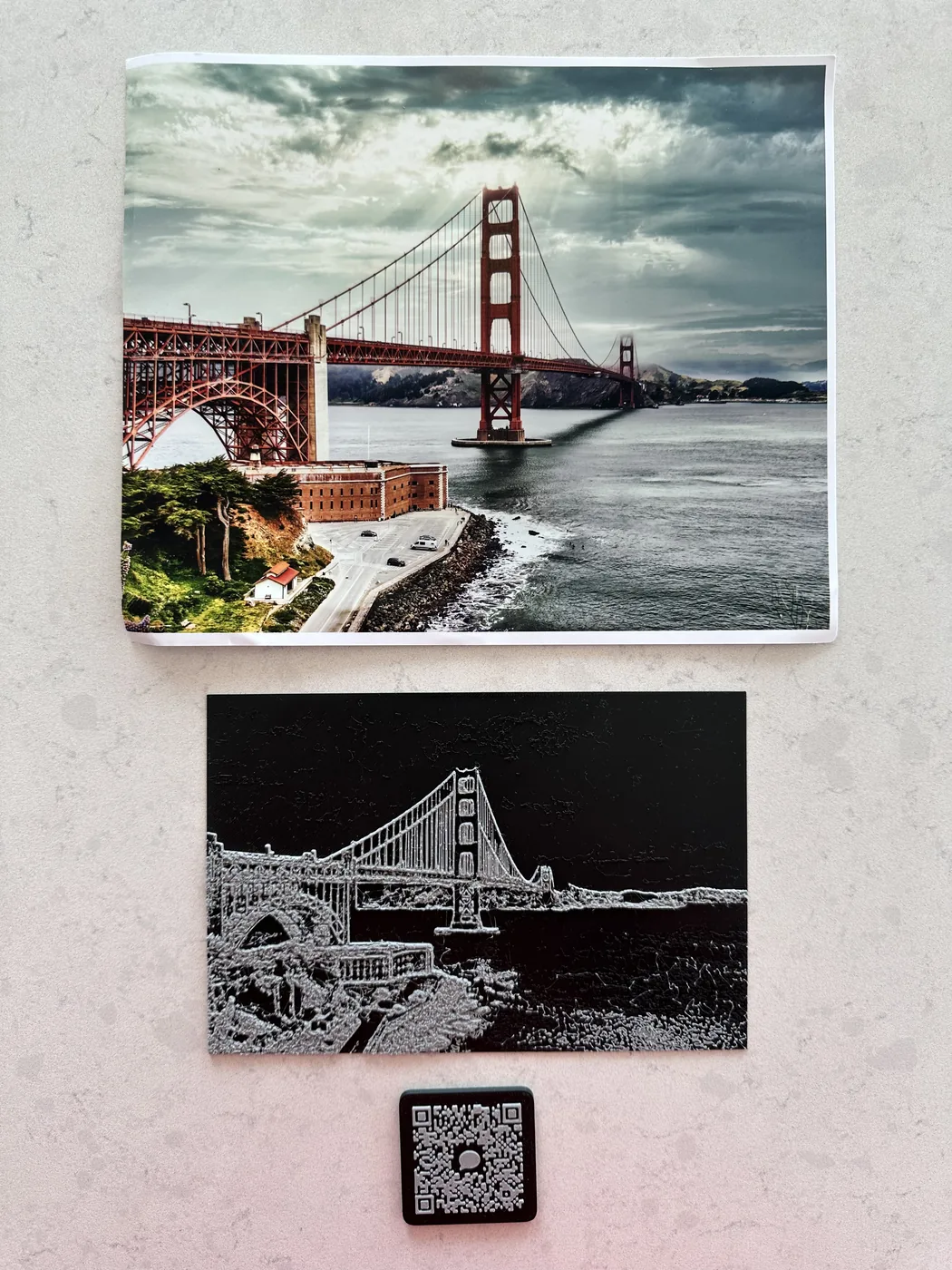 Photo of the Golden Gate Bridge taken by Ted. Below that is a tactile print of the photo. Underneath that is a tactile QR code that leads to an audio description about the image and tips on how to feel the tactile print.